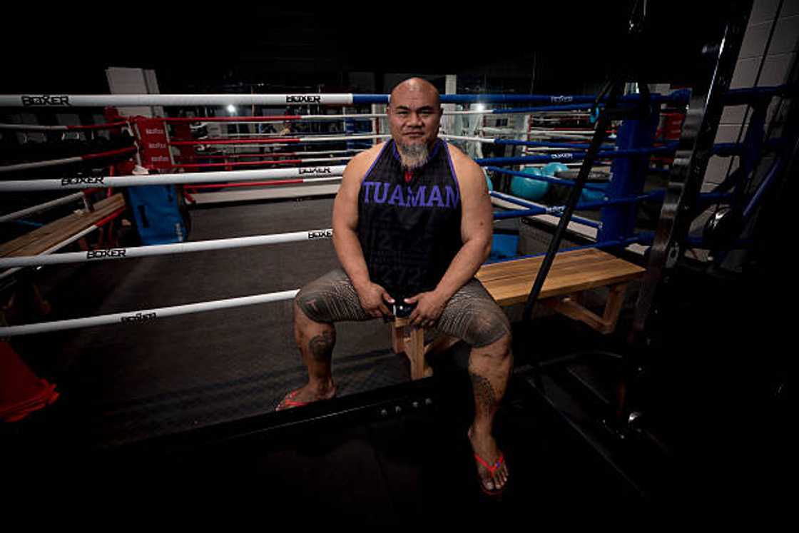Former heavyweight boxer David Tua sitting next to a boxing ring. Former heavyweight boxer David Tua sitting next to a boxing ring.