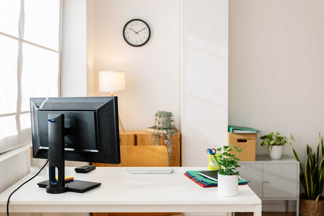 Small workplace at bright apartment