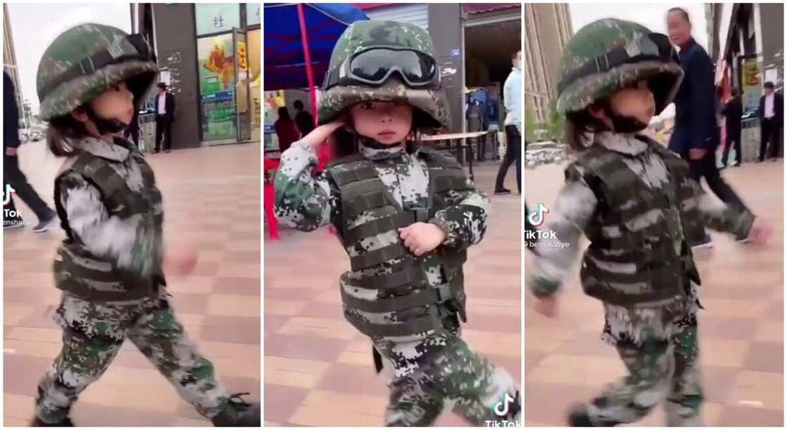 Kid salutes like a smart soldier.