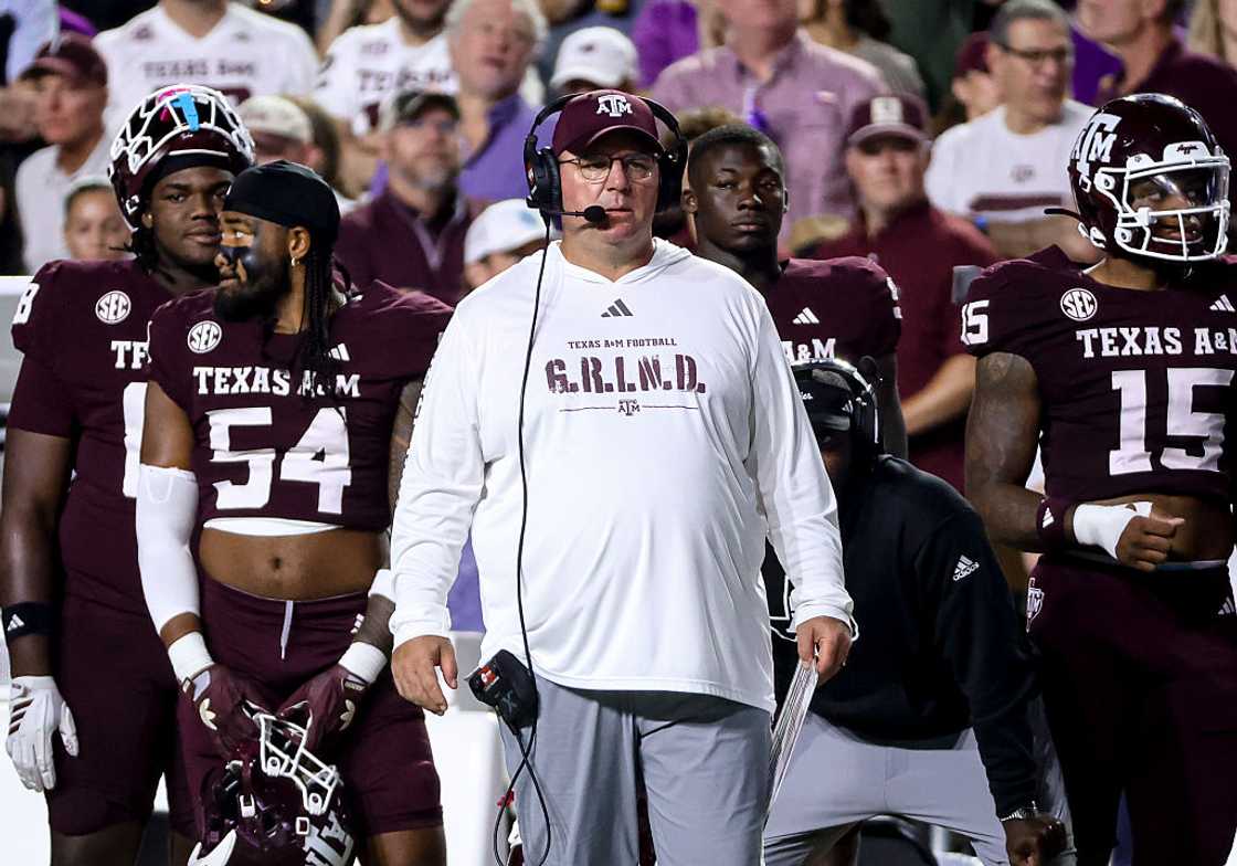 Mike Elko of the Texas A&M Aggies on the sideline with some of his players