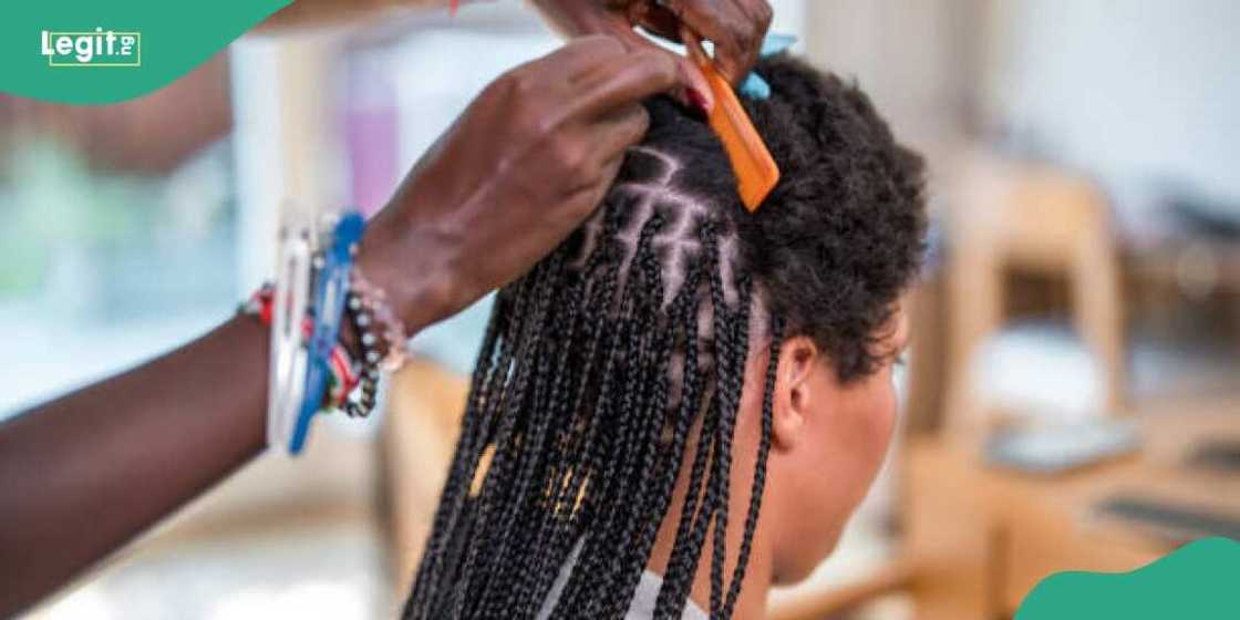 Lady rests on boyfriend while braiding her hair