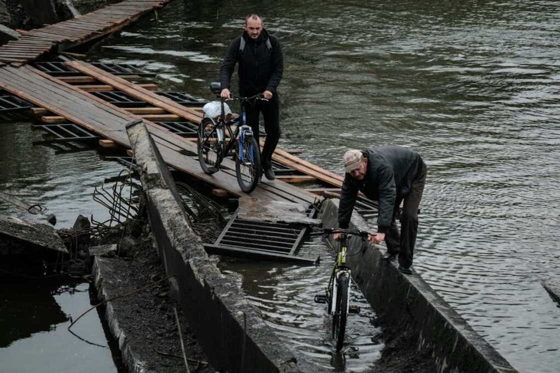 The main civilian river crossing in the fronline Ukrainian town of Bakhmut is a treacherous pile of wreckage and will only get more difficult as winter arrives