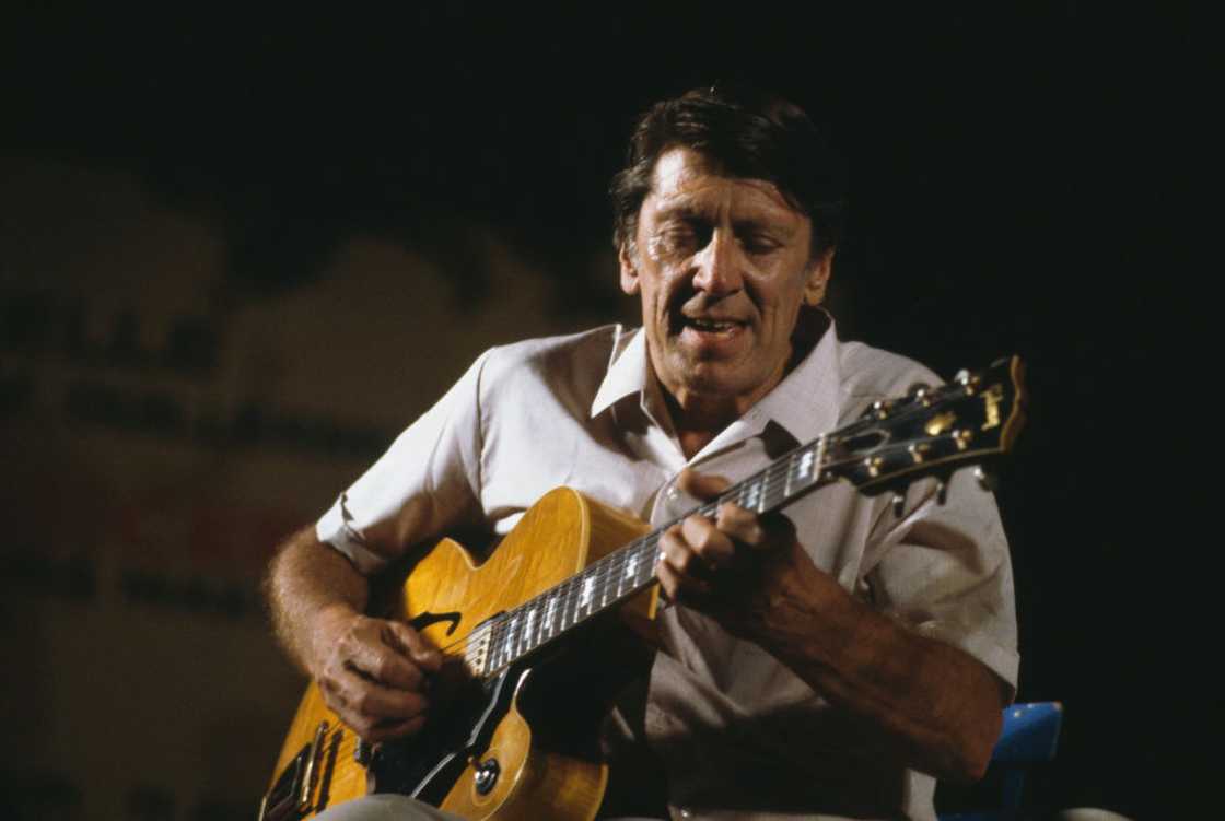 Tal Farlow playing the guitar during a live concert performance Tal Farlow playing the guitar during a live concert performance