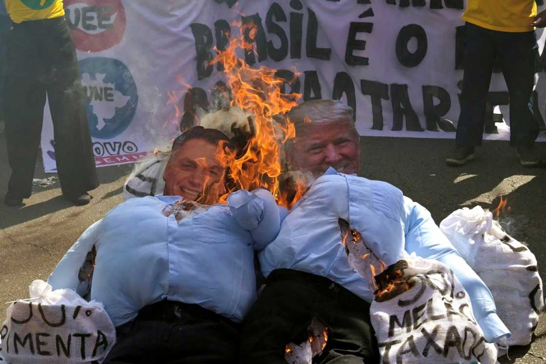 Dummies depicting US President Donald Trump (R) and Brazil's former President Jair Bolsonaro are burnt during a pro-national sovereignty protest following the US imposition of trade taxes and sanctions Dummies depicting US President Donald Trump (R) and Brazil's former President Jair Bolsonaro are burnt during a pro-national sovereignty protest following the US imposition of trade taxes and sanctions