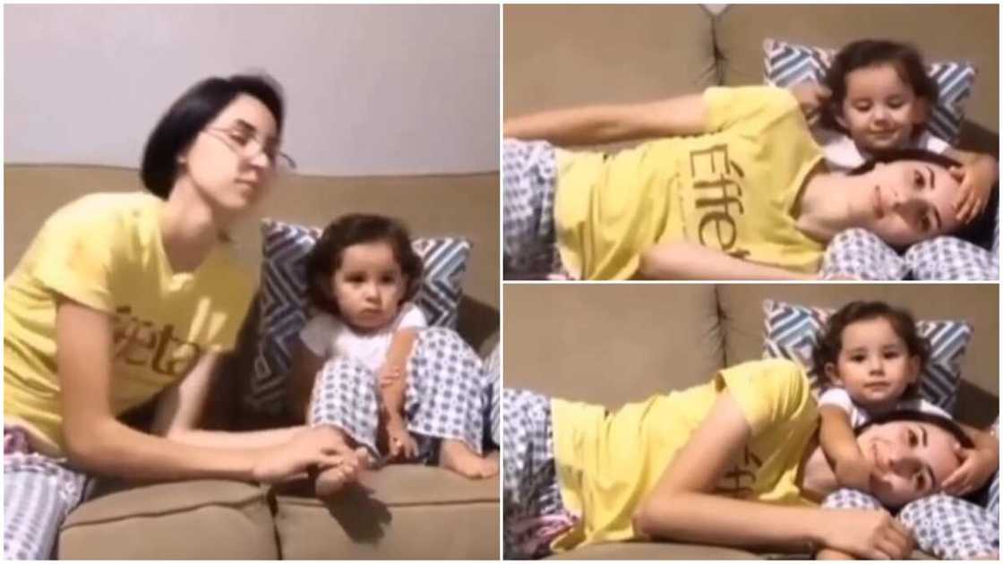 Beautiful moment mother rests on baby's legs, she pats her head in lovely way Beautiful moment mother rests on baby's legs, she pats her head in lovely way