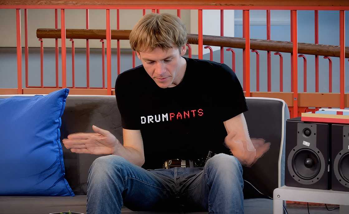 A man taps his legs to create music.