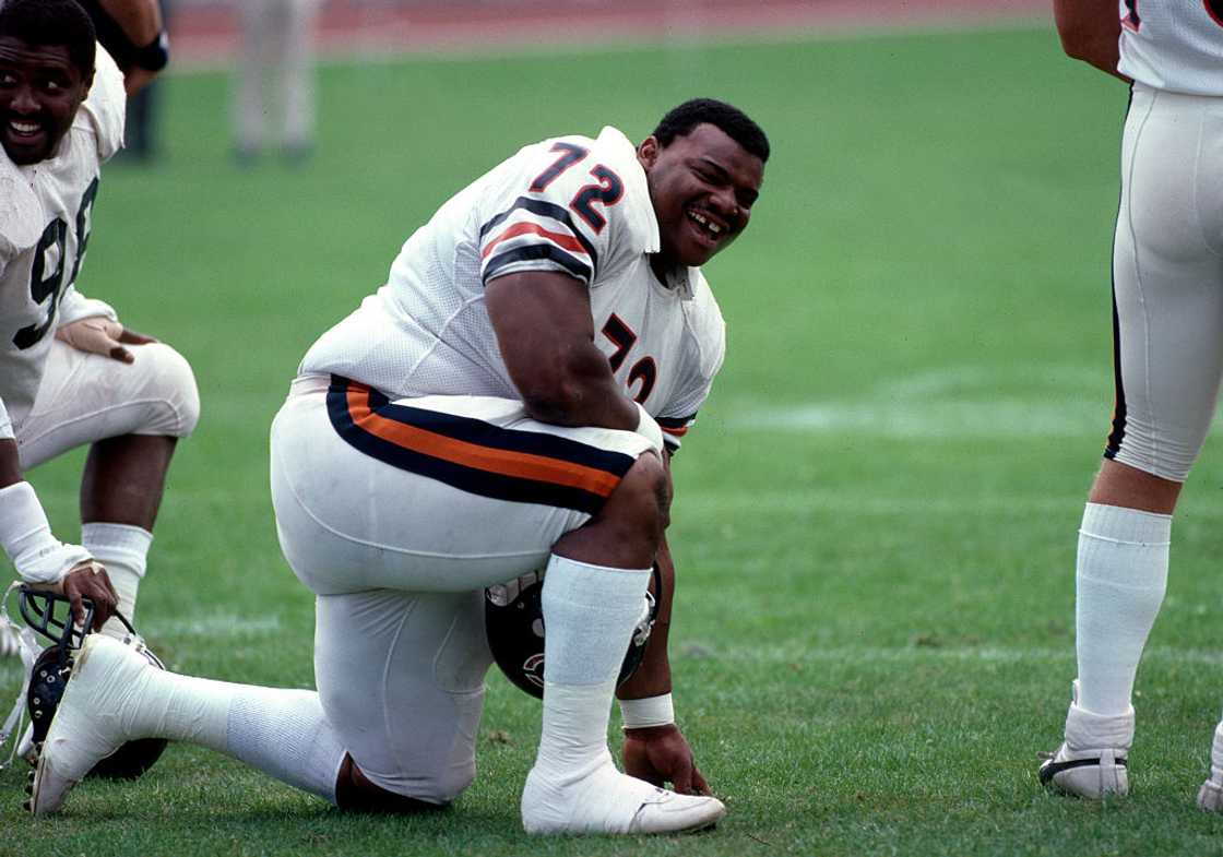 Chicago Bears Training - William 'The Refrigerator' Perry posing for a photo, laughs in training