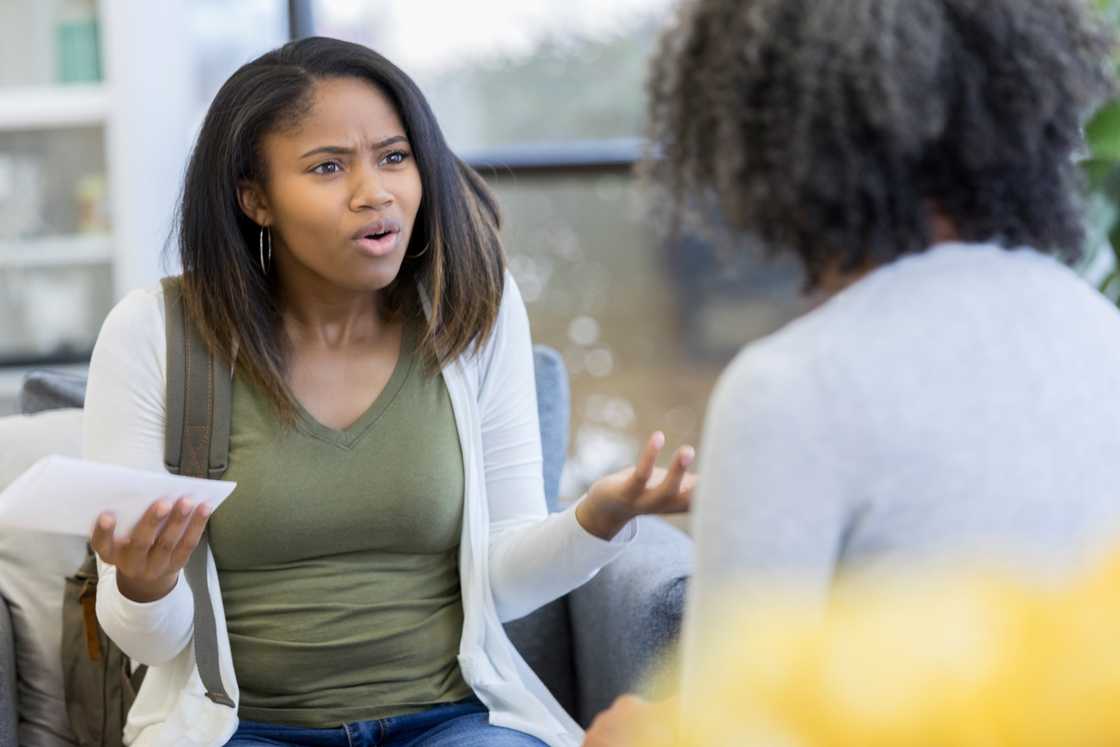 An angry young woman gestures while talking to a friend An angry young woman gestures while talking to a friend