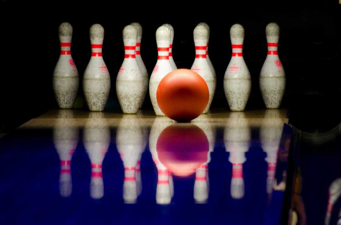 White bowling pins and red bowling ball