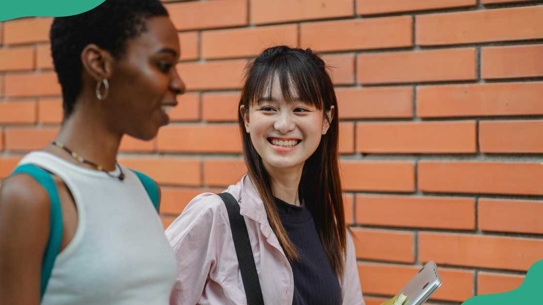 Two female students chatting Two female students chatting