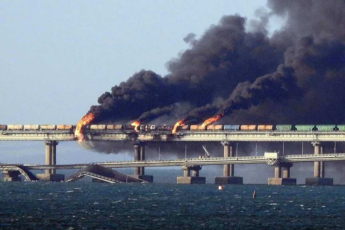 Black smoke billows from a fire on the Kerch bridge that links Crimea to Russia, after a truck exploded, near Kerch, on October 8, 2022 Black smoke billows from a fire on the Kerch bridge that links Crimea to Russia, after a truck exploded, near Kerch, on October 8, 2022