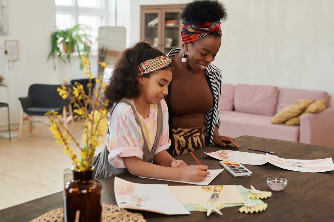 A mother and daughter bond over some drawings. A mother and daughter bond over some drawings.