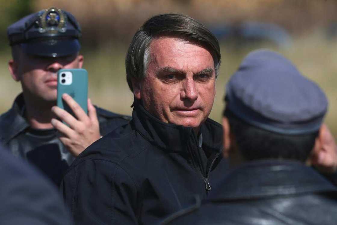 Brazil's President Jair Bolsonaro, seen here in May 2022, was caught on video grabbing a heckler by the shirt