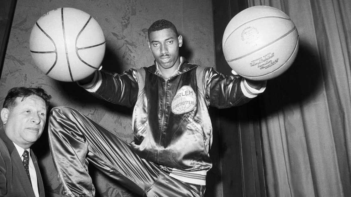 Wilt Chamberlain, poses holding two basketballs at the University of Kansas. Wilt Chamberlain, poses holding two basketballs at the University of Kansas.