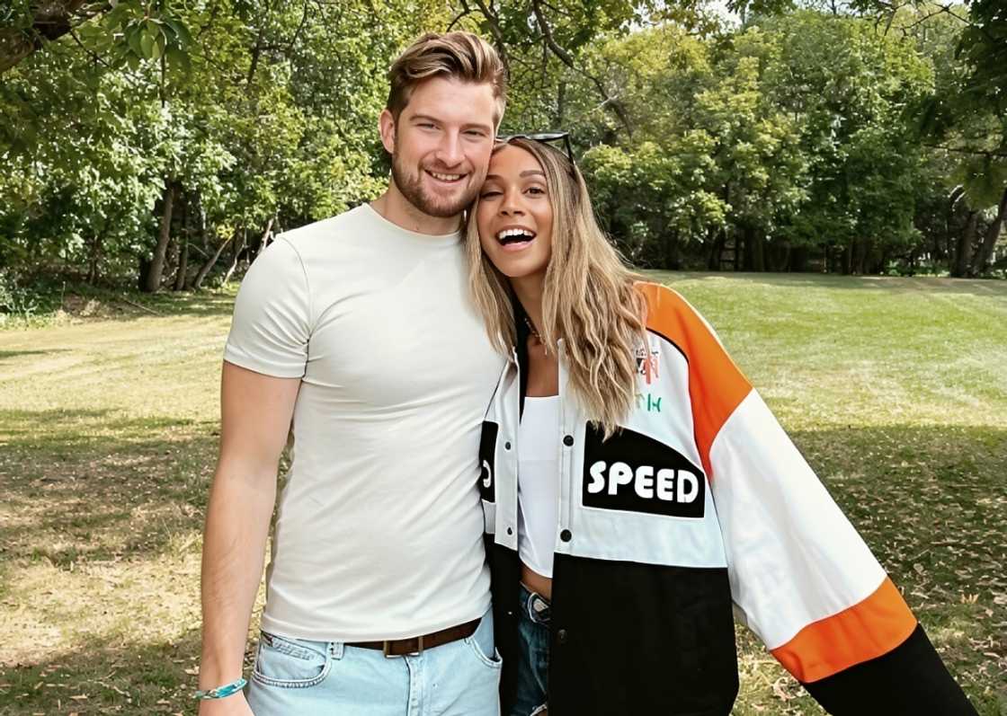Taylor and Bergie pose standing outdoors
