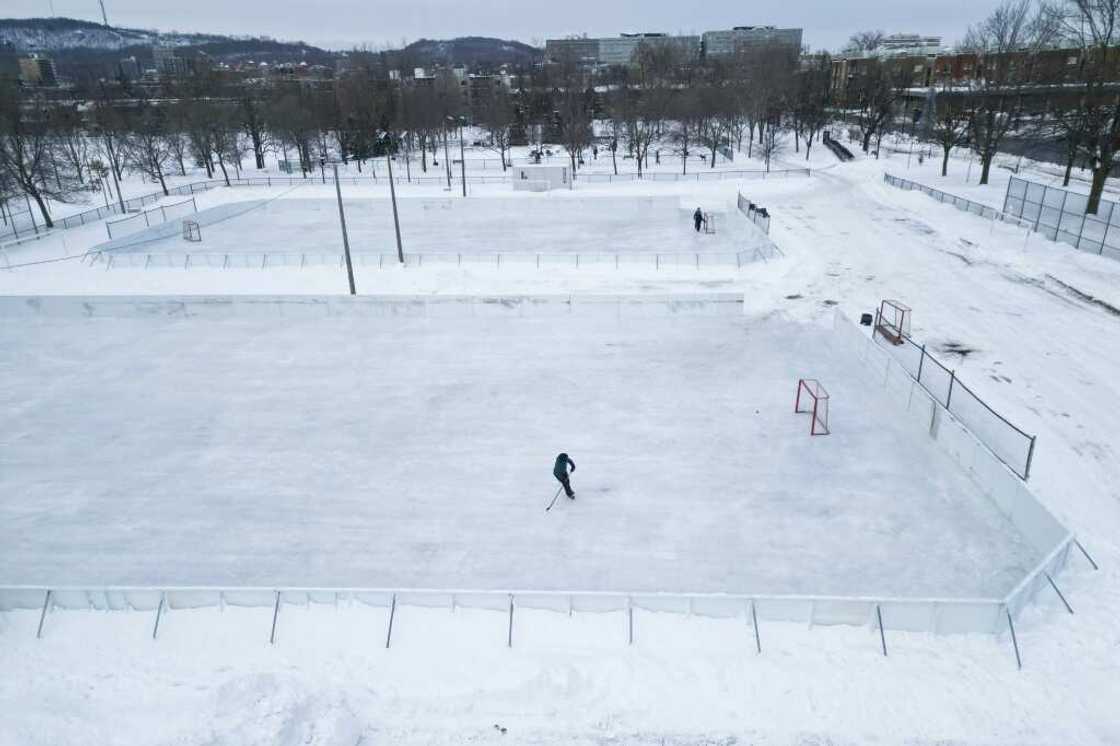 A hockey player skates on one of the few open outdoor ice rinks at Laurier Park in Motnreal A hockey player skates on one of the few open outdoor ice rinks at Laurier Park in Motnreal