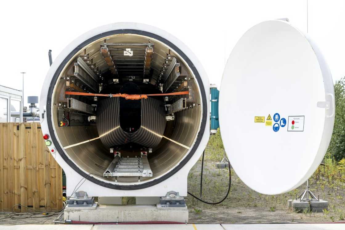 The dark and light grey striped pod inside the hyperloop tunnel at the European Hyperloop Center (EHC) testing facility in Veendam The dark and light grey striped pod inside the hyperloop tunnel at the European Hyperloop Center (EHC) testing facility in Veendam