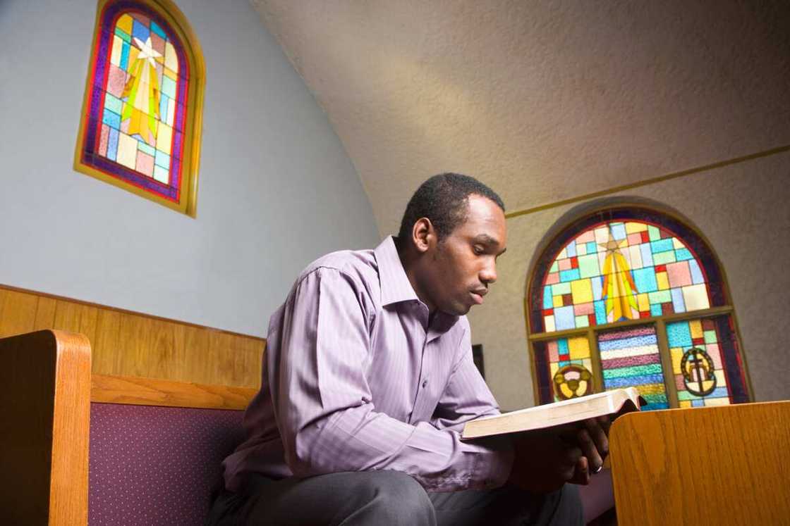 A man reading Bible in church