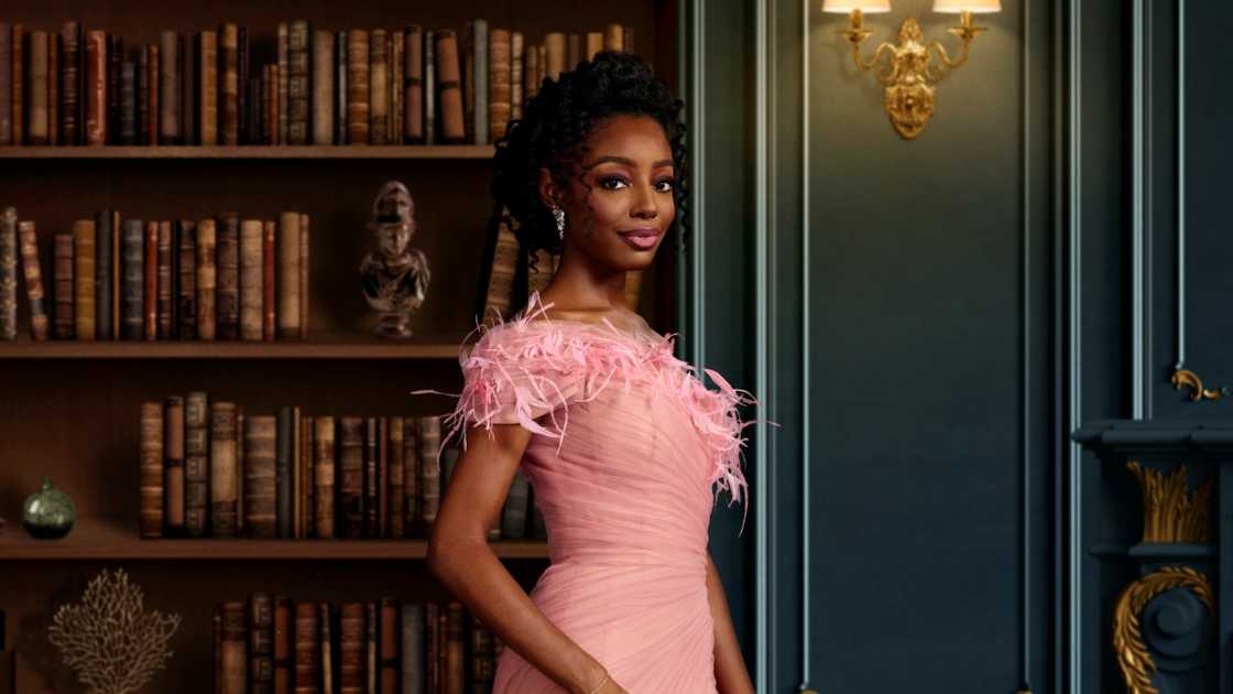 Venita Aspen poses standing for a portrait in a library. Venita Aspen poses standing for a portrait in a library.