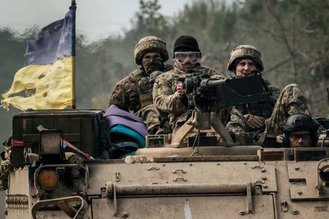 Ukrainian soldiers ride on an armoured vehicle near the recently retaken town of Lyman in Donetsk region Ukrainian soldiers ride on an armoured vehicle near the recently retaken town of Lyman in Donetsk region