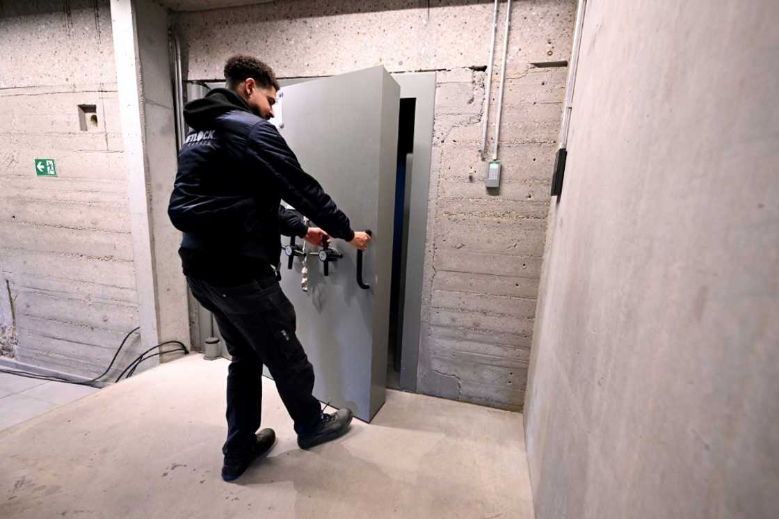 An employee opens a massive security door inside the storage room of Tradium, a company specialised in trading rare earths, near Frankfurt, western Germany