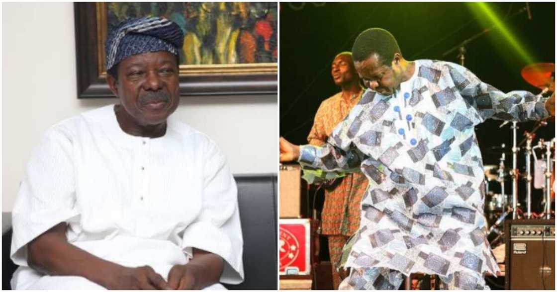 King Sunny Ade cautions crew member on stage. King Sunny Ade cautions crew member on stage.