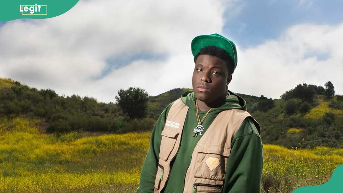 Rapper Rakeem Miles looks on as he takes solo picture Rapper Rakeem Miles looks on as he takes solo picture