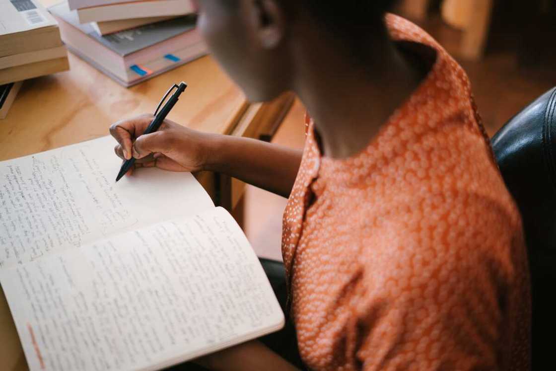 A student writing in a book