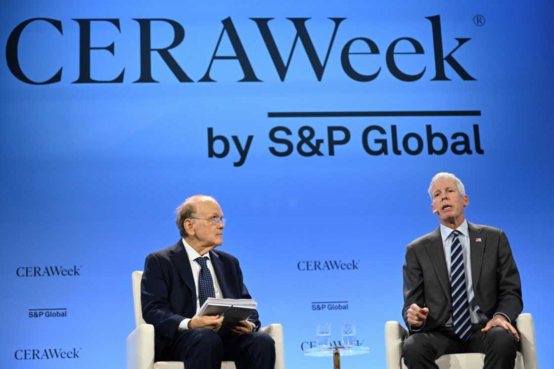 US Energy Secretary Chris Wright (R) speaks with the vice-chairman of S&P Global Daniel Yergin, in the framework of the Ceraweek by S&P Global energy conference in Houston, Texas