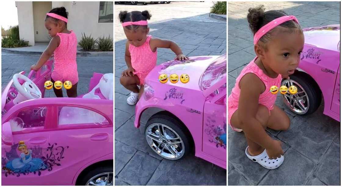 Black toddler in pink dress, squatting close to a pink toy car. Black toddler in pink dress, squatting close to a pink toy car.