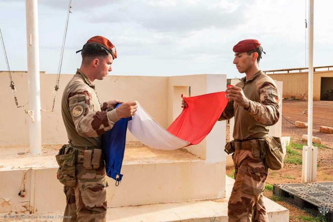 French soldiers folding up their flag as they left Mali in August French soldiers folding up their flag as they left Mali in August