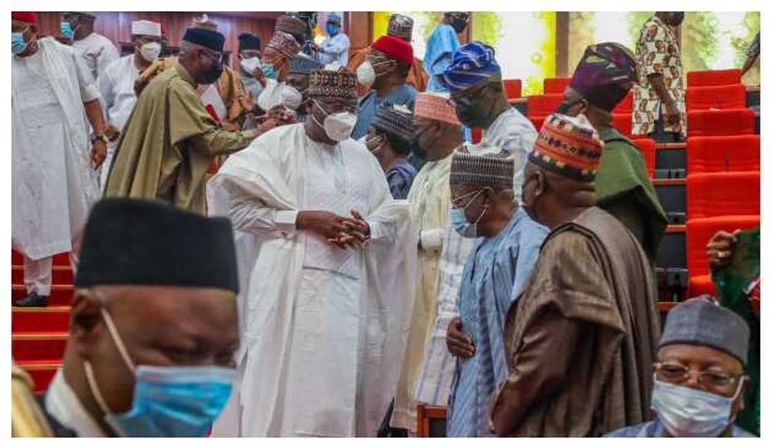 Lawan speaking with senators after plenary Lawan speaking with senators after plenary