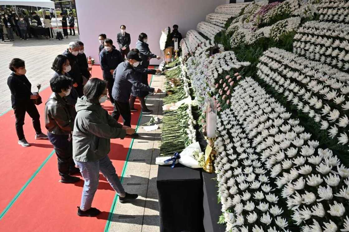 Mourners pay tribute in front of a joint memorial altar for victims of the deadly Halloween crowd surge in Seoul Mourners pay tribute in front of a joint memorial altar for victims of the deadly Halloween crowd surge in Seoul