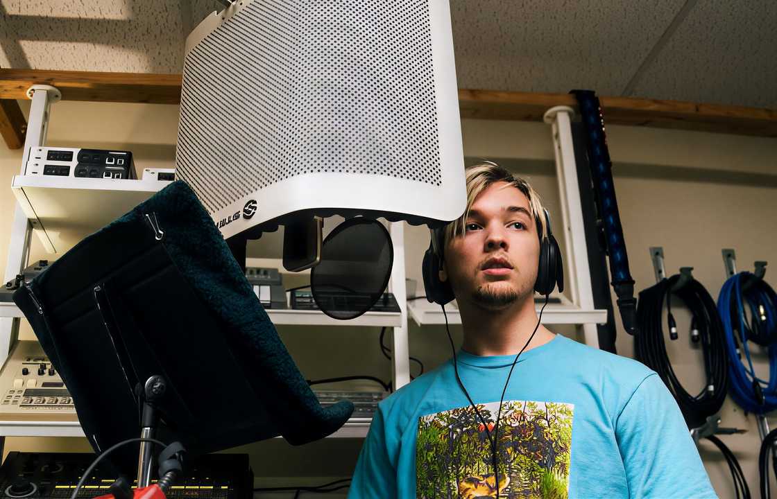 Elijah Hendrix Wahlberg wearing headphones and standing in front of a microphone, pictured in a studio. Elijah Hendrix Wahlberg wearing headphones and standing in front of a microphone, pictured in a studio.