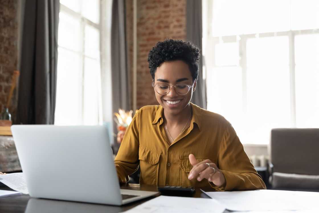 A young woman in glasses using a laptop computer.