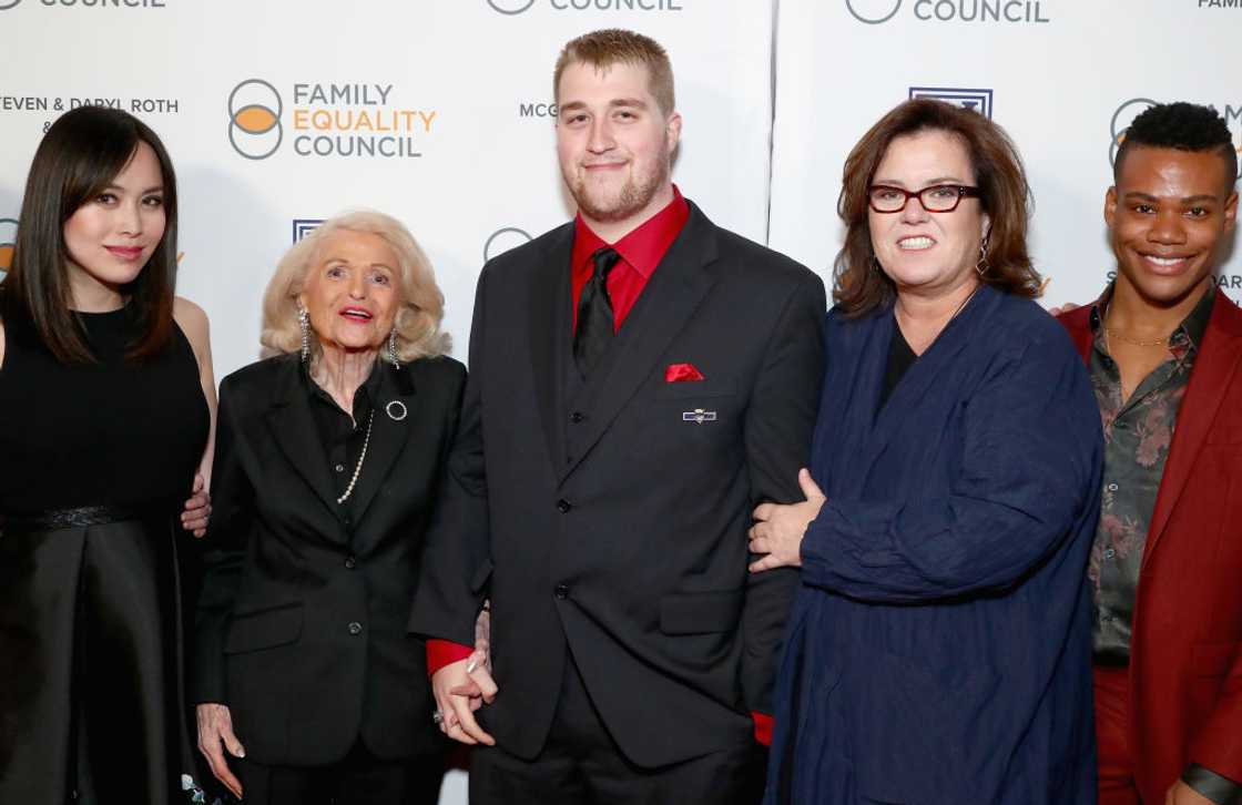 Parker O'Donnell (C) and his mother attends an event alongside other guests