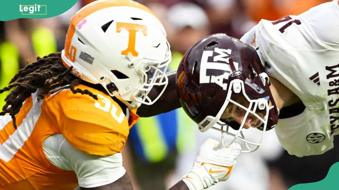 Roman Harrison, #30 of the Tennessee Volunteers, gets called for a face mask penalty against Max Johnson, #14 of the Texas A&M Aggies, in Knoxville, Tennessee