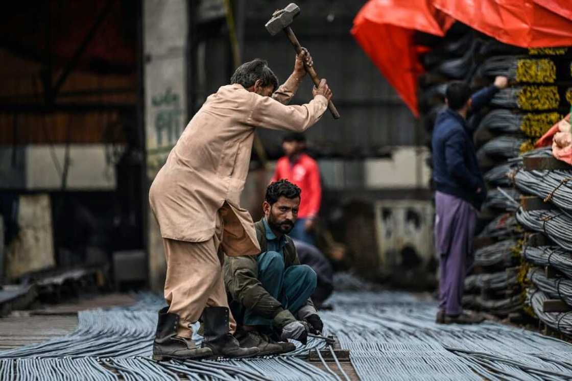 Labourers at a steel mill in Islamabad Labourers at a steel mill in Islamabad