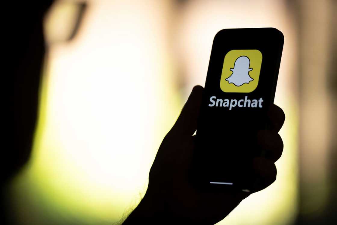 A Snapchat logo is seen on a phone screen