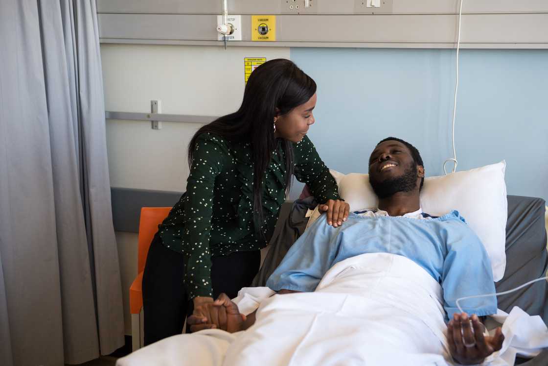 A lady is taking care of her partner in hospital