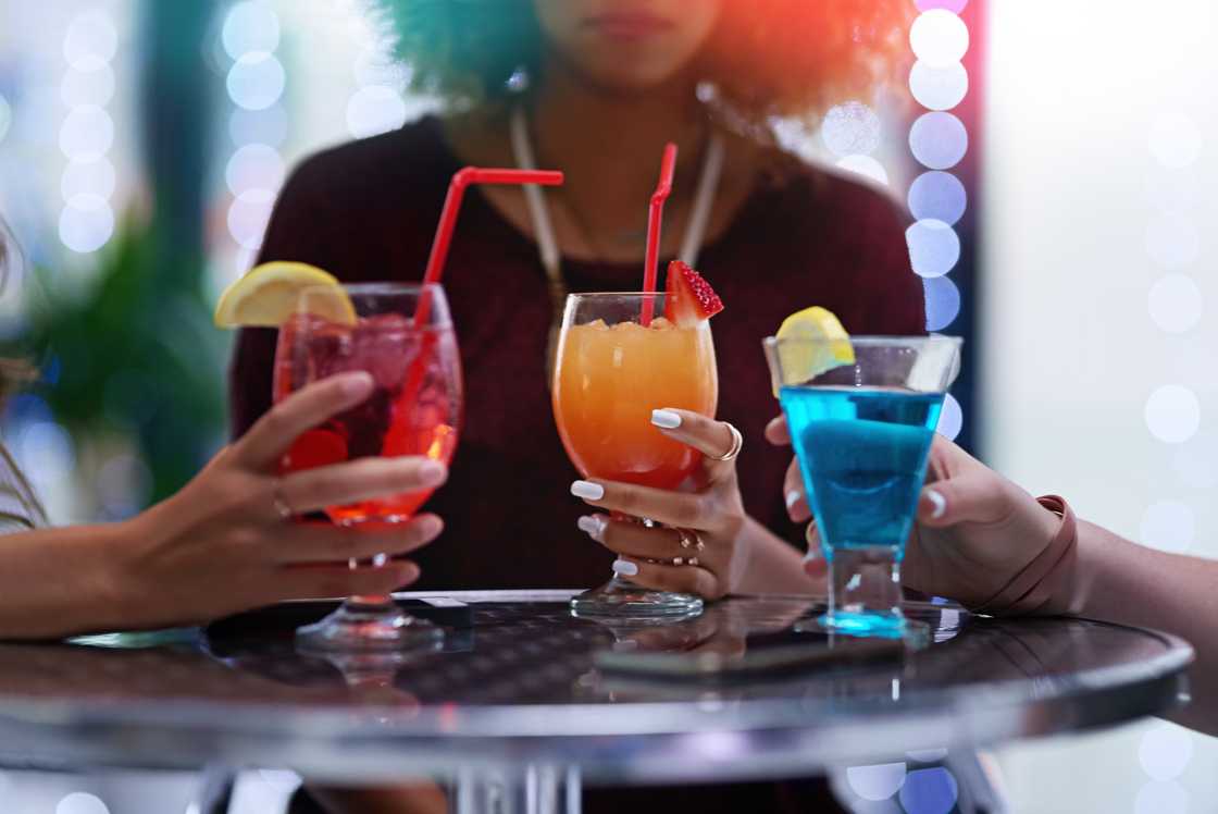 Cropped shot of a group of friends enjoying cocktails