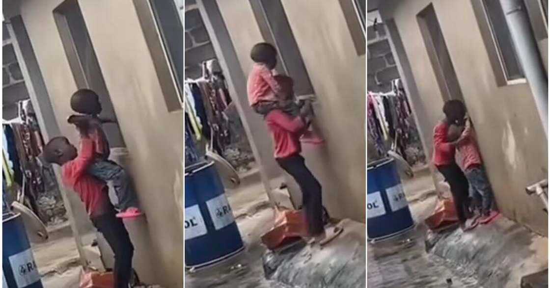 Little boy carries brother to watch television through neighbour's window Little boy carries brother to watch television through neighbour's window