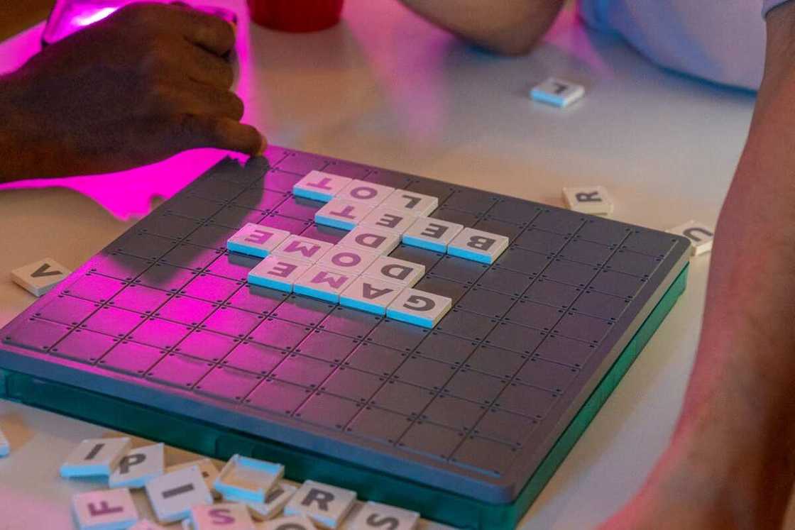 People playing a board game at a party People playing a board game at a party
