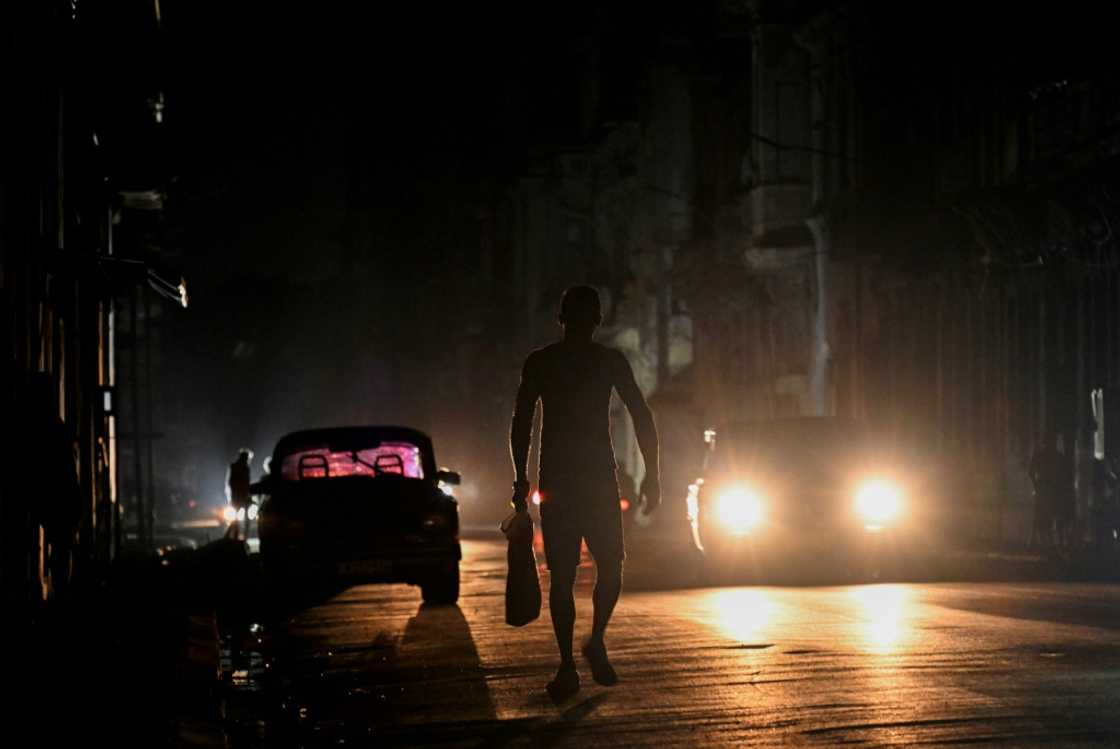 A man walks on a street during a general blackout in Havana A man walks on a street during a general blackout in Havana