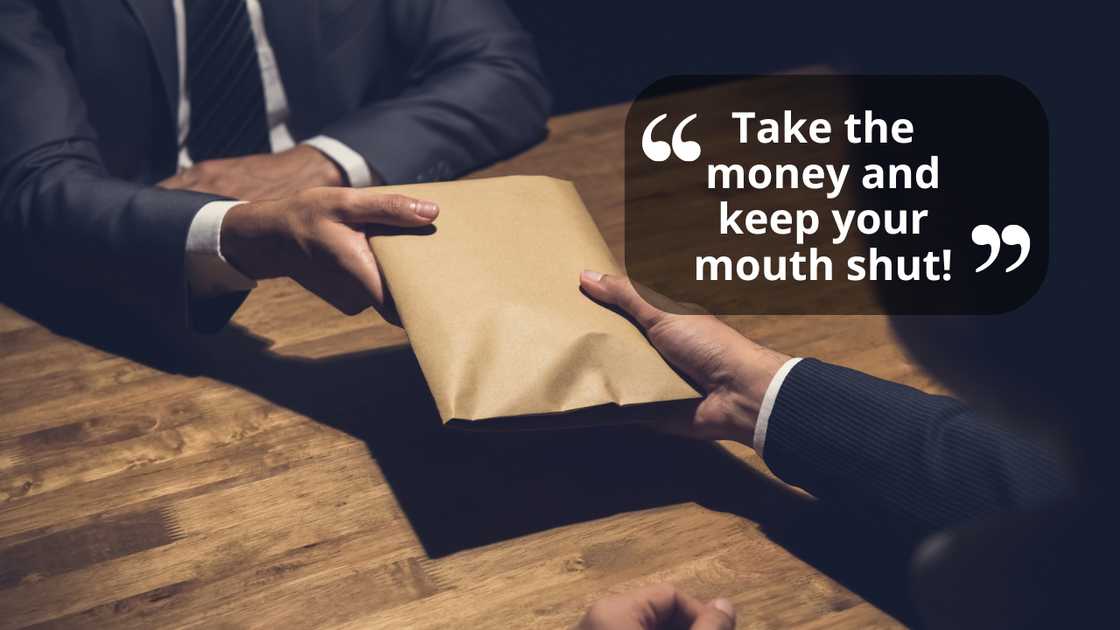 A man receiving money in an envelope A man receiving money in an envelope