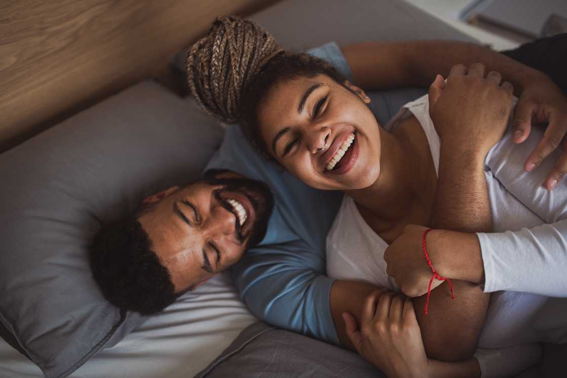 Man and woman resting in bedroom