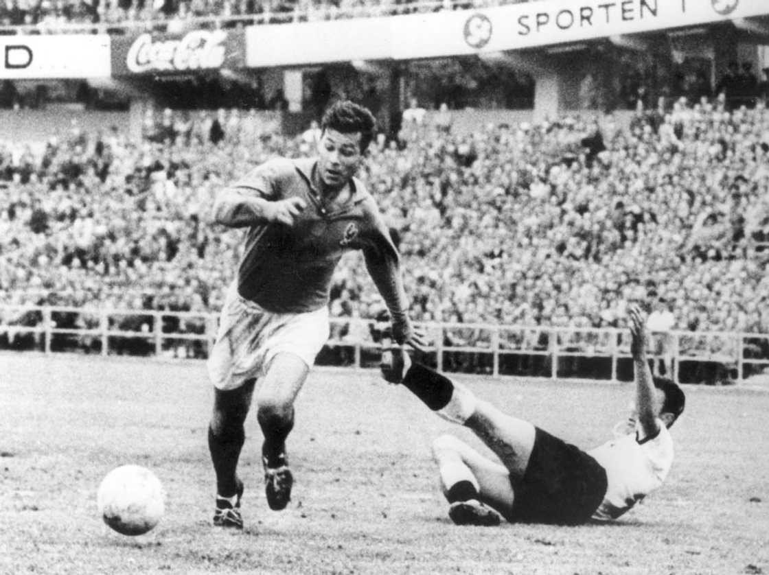 Just Fontaine dribbles past falling German player Alfred Kelbassa Just Fontaine dribbles past falling German player Alfred Kelbassa