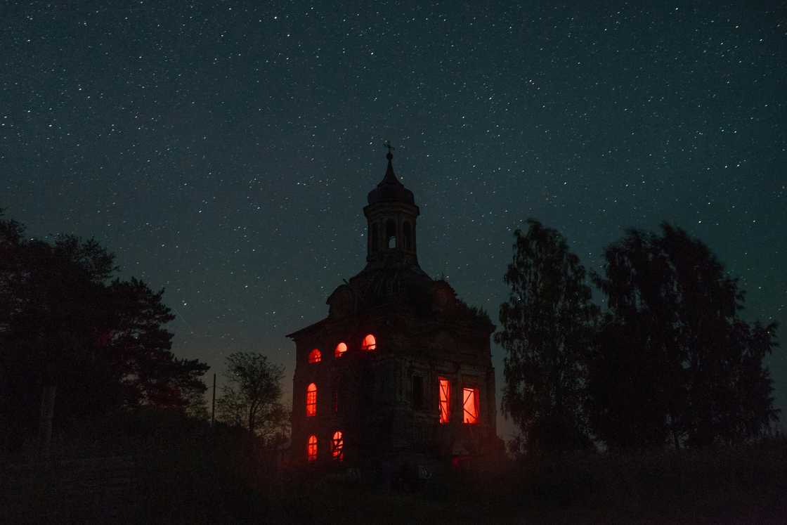 A spooky building in the dark with red lights A spooky building in the dark with red lights