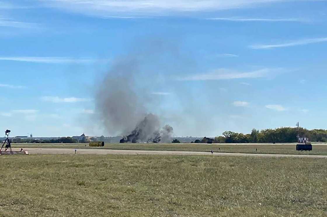 Smoke rises from the crash site after two planes collided mid-air during the Wings Over Dallas Airshow on November 12, 2022 Smoke rises from the crash site after two planes collided mid-air during the Wings Over Dallas Airshow on November 12, 2022
