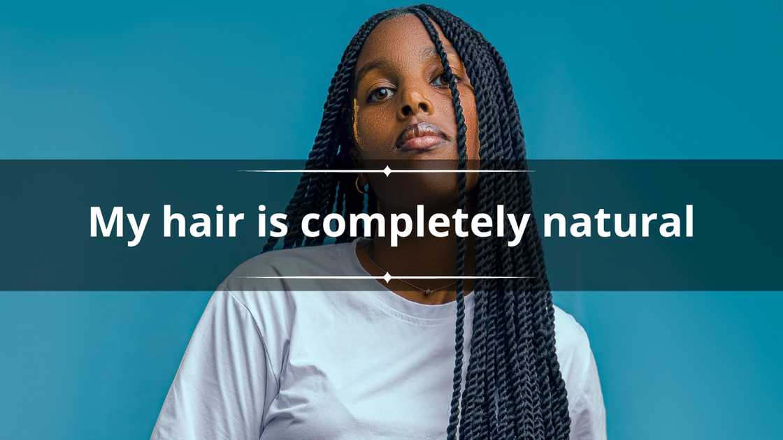 A young woman in braided hair posing against a blue background A young woman in braided hair posing against a blue background